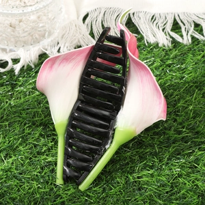 Elegant black Calla Lily hair claw clip on grass background for summer hair styling