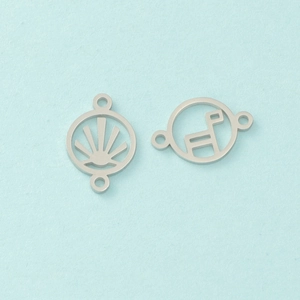 Macro detail of geometric hollow silver stainless steel charms on a blue background