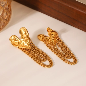 Detail of 18K gold stainless steel heart studs with lava texture and fringe chains