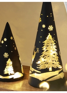 Detail of black conical Christmas lights with laser-cut reindeer and snowflake patterns