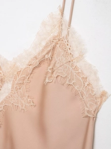 Detail of champagne satin top featuring delicate eyelash lace trim at the neckline