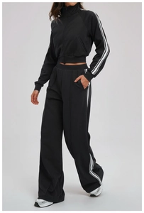 Detail of black sports jacket with white side stripes and smooth zipper pocket design