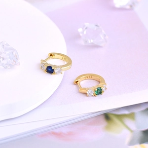 Detail of S925 sterling silver hoop earrings with blue and green zircon stones