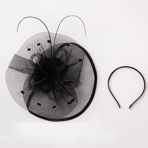 Detail shot of black mesh bridal fascinator with elegant feathers and matching headband