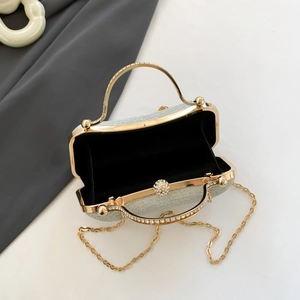Silver glitter clutch bag with gold handle and chain strap for evening events