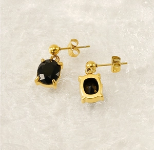 Detail view of oval black zircon earrings in 18K gold-plated stainless steel with 4-prong setting