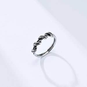 Detail of silver twisted wire ring with vintage braided texture on white background