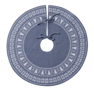Detail of blue-grey knitted Christmas tree skirt with white snowflake and tree patterns
