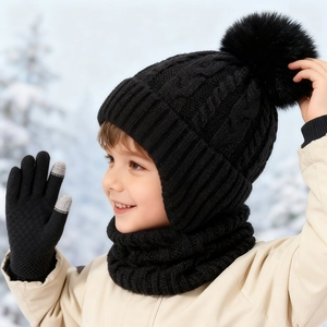 Detailed cable knit pattern on black kids winter beanie with faux fur pom and neck warmer