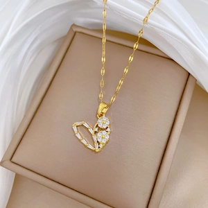 Gold heart necklace with sparkling cubic zirconia flower charm on decorative chain