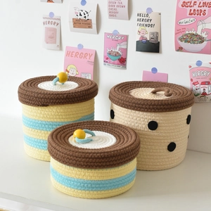 Three-piece set of woven cotton rope storage baskets with lids featuring dots and stripes