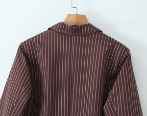 Macro view of brown pinstripe blazer back detail showing fabric texture and tailoring