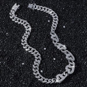 Silver iced-out Cuban link chain necklace with sparkling crystals on black background
