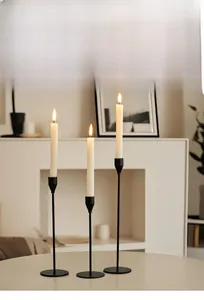Three-piece black minimalist iron candle holders in high, medium, and low sizes for home