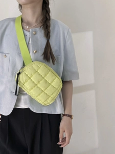 Lemon yellow quilted puffer crossbody bag with wide strap and zip for outdoor activities