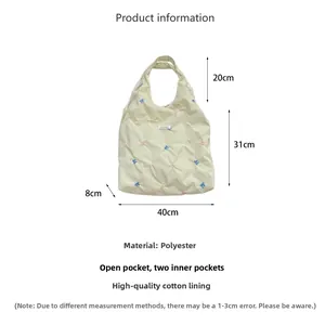 Detailed size chart for beige butterfly embroidered quilted canvas tote bag showing dimensions