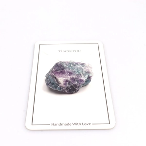 Macro shot of natural raw fluorite stone with purple and green textures on thank you card