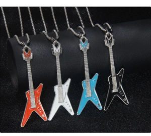 Detail of colorful guitar pendants in orange white blue and black with sparkling rhinestones