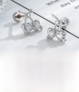 Macro shot of silver cherry ear stud with micro-set zircon and heart-shaped detail