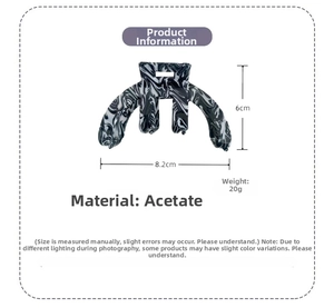 Detail view of 8.2cm acetate hair claw clip featuring black and white marble ink patterns
