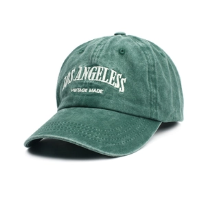 Detailed close-up of vintage washed green cotton baseball cap with Los Angeles embroidery