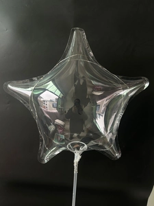 Detailed view of a star-shaped transparent LED balloon with colorful lights and handle