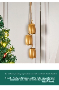 Close-up of golden vintage cowbells with hemp rope hanging by a Christmas tree