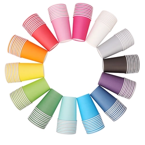 Rainbow circle of colorful disposable paper cups with white striped rims on white background