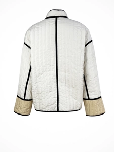 Detailed back view of women's quilted jacket with vertical stitching and color-block piping