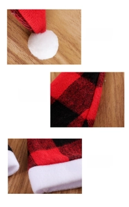 Detailed view of red black buffalo plaid Christmas hat with white pom-pom and neat stitching