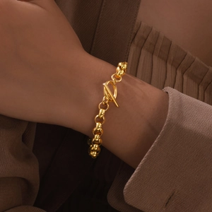 Minimalist gold stainless steel chain bracelet for women featuring a stylish OT toggle clasp