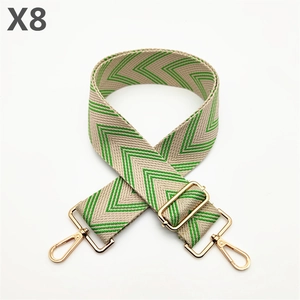 Detail of adjustable beige and green chevron canvas strap with gold metal hooks