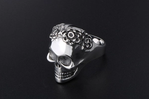Macro view of gothic skull ring with floral engraving and polished silver finish