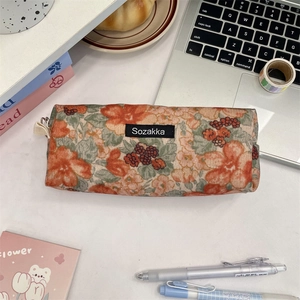 Macro view of vintage floral pencil case with canvas texture and durable zipper detail