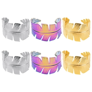 Leaf-shaped open cuff bracelets in gold, silver and iridescent finishes on white background