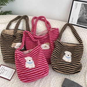 Detail of plush striped tote bags featuring cute cartoon dog embroidery and large capacity