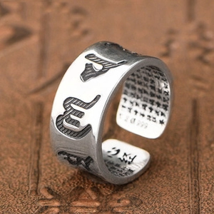Macro shot of S999 silver open ring featuring engraved Heart Sutra inside and Sanskrit symbols