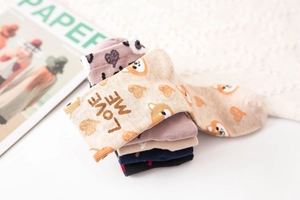 Detailed close-up of colorful cotton socks with shiba inu patterns and love me text design