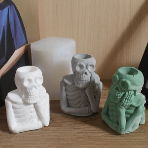 DIY silicone mold for skull head candle holders in white, grey, and green resin