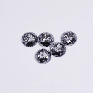 Top view of five hemispherical resin charms with black and silver hexagonal sequins