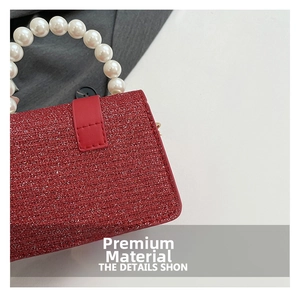Detail of red sequin fabric texture with elegant pearl handle and metal rings