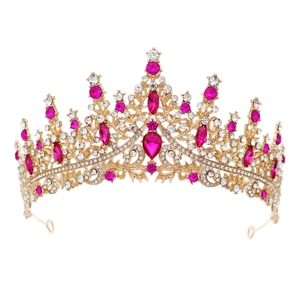 Detail of pink crystal crown with golden metal base and sparkling clear rhinestones