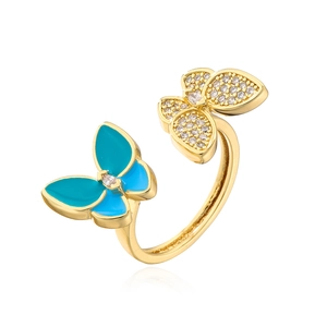 Detail of 18K gold butterfly ring featuring blue enamel and sparkling cubic zirconia
