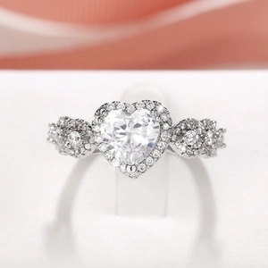 Macro view of heart-cut zircon ring with halo setting and pave diamond accents