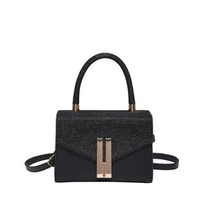Elegant black handbag with glitter flap and matte leather body featuring gold accents