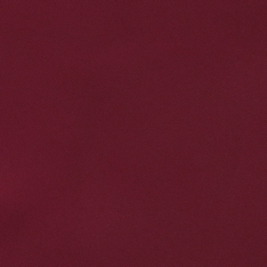Macro shot of burgundy evening gown fabric showing detailed twill texture and weave