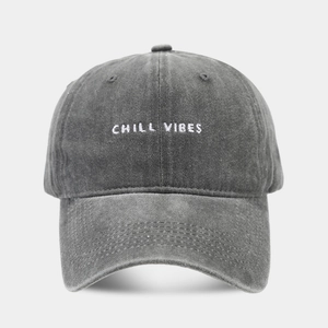 Close-up of CHILL VIBES embroidery on washed dark gray cotton baseball cap