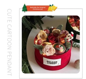 Close-up of red velvet Christmas floral box with LED lights, roses, and holiday decorations