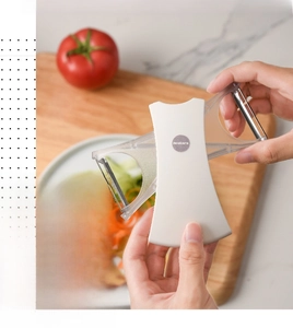 Close-up of dual-blade vegetable peeler showing 360-degree rotating head function