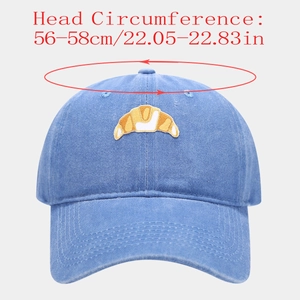 Detail of croissant embroidery on washed blue cotton cap with 56-58cm size info